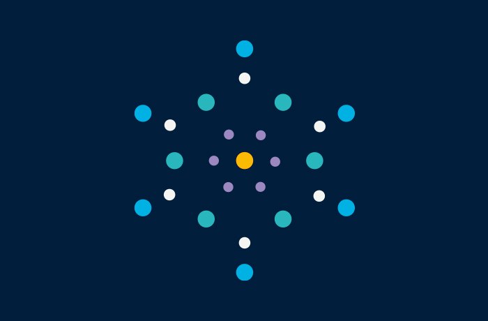 Ein geometrisches Muster aus farbigen Kreisen auf dunkelblauem Hintergrund, die radial um einen zentralen gelben Punkt angeordnet sind, erinnert an die symmetrische Präzision des Logos des Ministeriums für Gesundheit, wobei die Ringe in Lila, Petrol, Blau und Weiß eine sternförmige Form bilden.