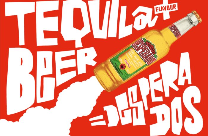 Eine Flasche Desperados Tequila Flavour Bier erscheint als Rakete mit stilisiertem weißem Rauch und fetter, gezackter weißer Schrift auf rotem Hintergrund mit der Aufschrift "TEQUILA BEER = DOS OPERADOS".